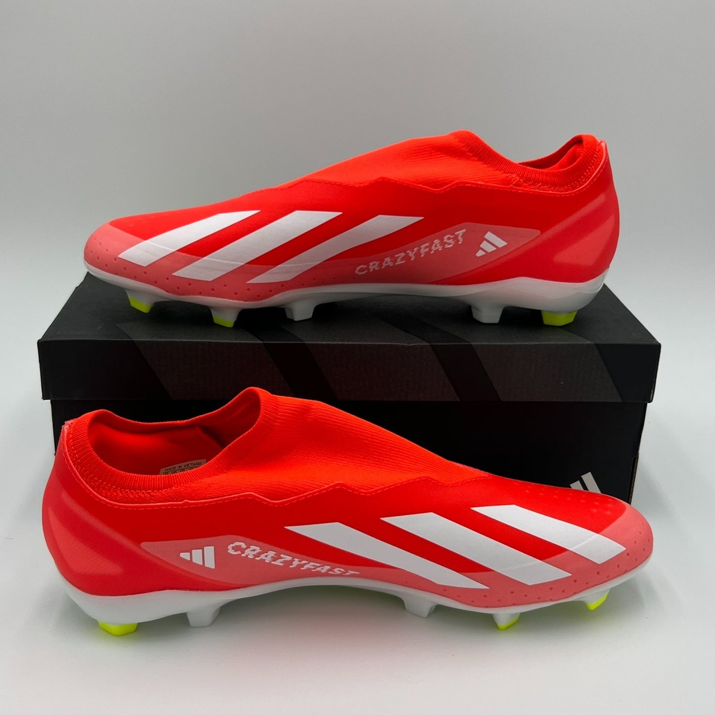 Red soccer cleats with white stripes and 'Crazyfast' text on a white background